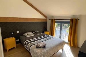 Un dormitorio con una cama grande y una ventana en La Remise des Amis - Maison rénovée au calme, en Peyriac-de-Mer