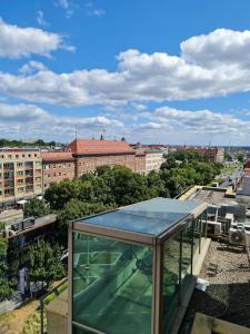 a glass house with a view of a city at Apartament plac Żołnierza Szczecin Polska in Szczecin