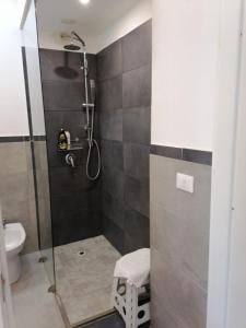 a bathroom with a shower with a toilet and a sink at B&B Atlante in Palermo