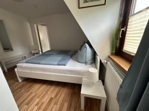 a small bedroom with a bed in a small room at Gästehaus Bremer in Cuxhaven