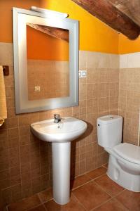 a bathroom with a sink and a toilet at LA CABAÑA DE SARA in Vinuesa