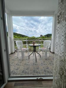 a patio with a table and chairs on a balcony at Apartment Kovach Kuti in Herceg-Novi