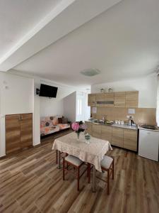 a kitchen with a table and chairs in a room at Apartment Kovach Kuti in Herceg-Novi +9 photos