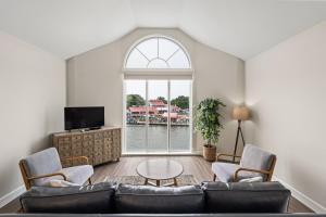 a living room with a couch and chairs and a window at St Michaels Harbour Inn, Marina and Spa in Saint Michaels