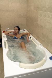 a woman sitting in a bath tub at Villa Angela Hotel & Spa in Ischia