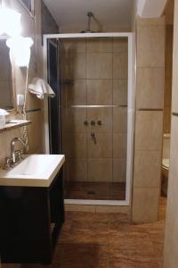 een badkamer met een douche en een wastafel bij HL Hotel in Cipolletti