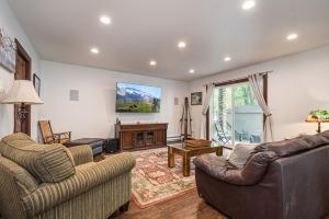a living room with two couches and a tv at Bear Trap in Swanton +29 photos