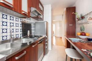 a kitchen with a sink and a stove at SuperApart Inflancka 19 ROOMS in Warsaw