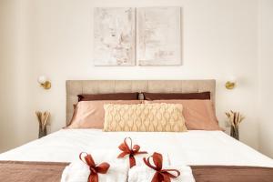 a bedroom with a bed with two bows on it at Relais Milano Suite 1 in Milan