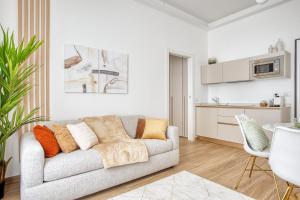 a living room with a couch and a kitchen at Relais Milano Suite 1 in Milan