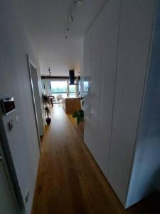 a hallway of an apartment with white walls and wooden floors at Luxury Apartment Ljubljana in Ljubljana