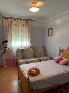 a bedroom with a bed with a stuffed animal on it at Apartamento en el parque natural in El Cabo de Gata