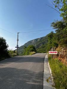a road with a sign on the side of the road at Apartman Oasis in Kotor