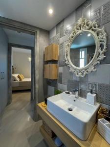 a bathroom with a sink and a mirror on the wall at Just Live in Triovasálos