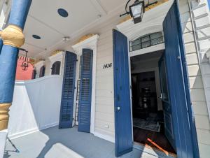 a porch with blue shutters on a house at Royal Residence in New Orleans