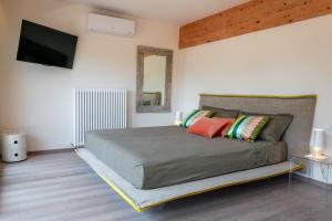 a bedroom with a bed and a flat screen tv at Charming Loft Lake Garda in Riva del Garda