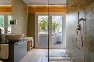 a bathroom with a shower and a sink and a tub at Charming Loft Lake Garda in Riva del Garda