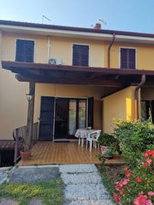 a house with a patio with a table and chairs at Omary in Colà di Lazise