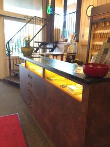 a counter in a store with a red bowl on it at Hotel Imperial in Hamburg