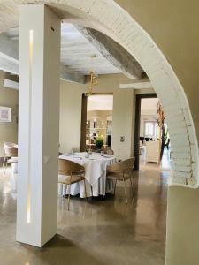 una sala da pranzo con tavolo e sedie bianchi di Locanda Granducato a Chiusi