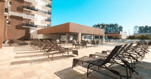 a group of chairs and tables and a building at Spazzio DiRoma / Acqua park in Caldas Novas