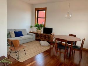 sala de estar con mesa y sofá en Ferreira Borges Nomadic Ap A en Oporto