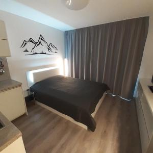 A bed or beds in a room at Mountain View Studio Apartment