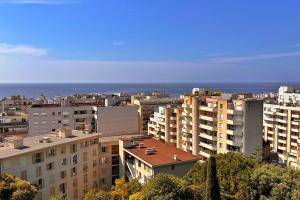 a view of a city with buildings and the ocean at Le Palais Riviera in Nice