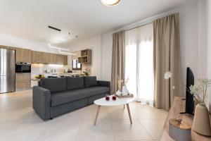 a living room with a couch and a table at Naxos Alma House in Naxos Chora