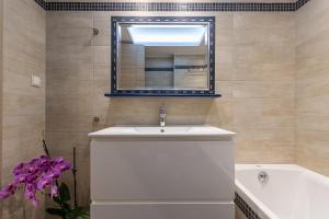 a bathroom with a sink and a mirror and a tub at Naxos Alma House in Naxos Chora +13 photos