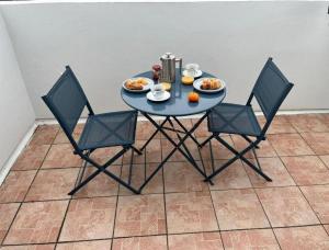 a blue table with chairs and food on it at Causeway Coast Sea Shore Apartment - Ballycastle in Ballycastle