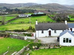an aerial view of a white cottage in a green field at Carol Cottage in Newry