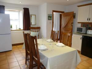 a kitchen with a table with a white table cloth at Carol Cottage in Newry