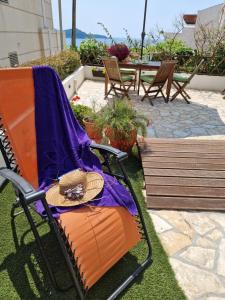 a rocking chair with a hat sitting on a patio at Bel Posto Apartment in Dubrovnik