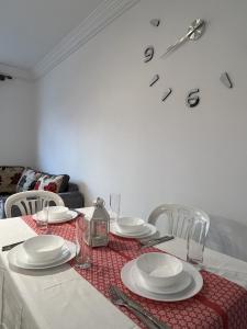 a dining room table with plates and glasses on it at Appartement Cosy, Calme M'diq in M'diq