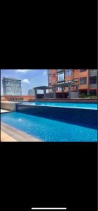 a picture of a swimming pool in front of some buildings at 2 BR Portovita Tower 12-A in Manila