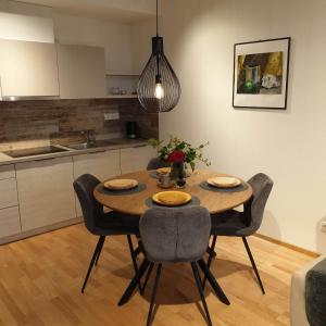 Una mesa de comedor y sillas en una cocina. en STUNNING VIEW APARTMENT NEAR FERRY TO SMILTYNĖ, en Klaipėda 19 fotos más