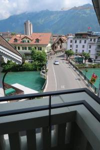 a view from a balcony of a city with a street at Aparthotel Krone - Self Check-In in Interlaken