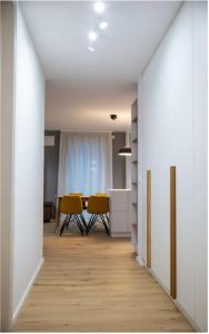 a dining room with a table and yellow chairs at The Garden Loft in Frankfurt/Main