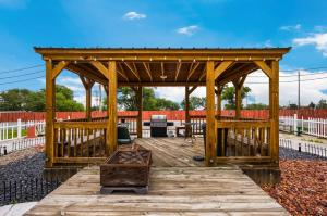 a wooden gazebo with a table on a wooden deck at Knights Inn Oakley in Oakley