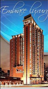 una imagen de un gran edificio con las palabras hotel Ambassador en 2 BR Portovita Tower 12-A, en Manila