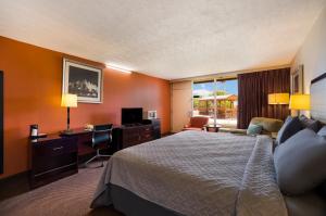 a hotel room with a bed and a desk at Knights Inn Oakley in Oakley