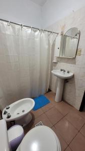 a bathroom with a toilet and a sink at Dpto solana in Rosario de la Frontera