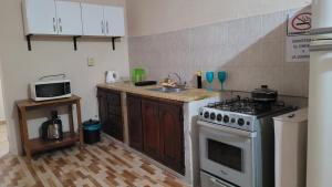 a kitchen with a stove and a sink at Dpto solana in Rosario de la Frontera