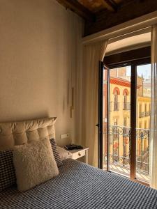1 dormitorio con 1 cama y vistas a un edificio en CETTI - Centro, en Granada