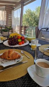 a table with a plate of food and a cup of coffee at Mobile Home PLAGE in Drage