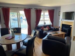 a living room with a couch and a table at Five bedroom waterfront house in Carrick on Shannon