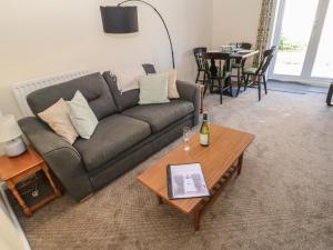 a living room with a couch and a table at 66 Dale Grove in Leyburn