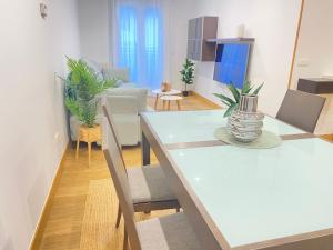 a living room with a white table and chairs at Mikain Terrace Cathedral View with Free Parking & Air Cond in San Sebastián