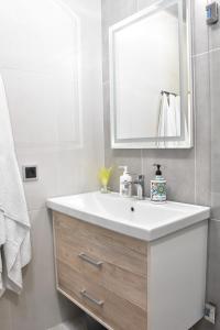 a bathroom with a white sink and a mirror at Apartment in Erebuni in Yerevan